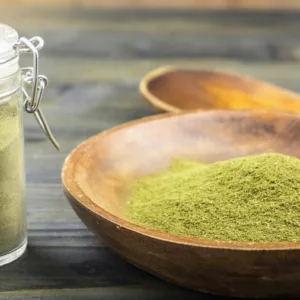 Natural pain reliever Kratom in a mixing bowl at our organic apothecary herbal shop in Borneo being measured to sell.