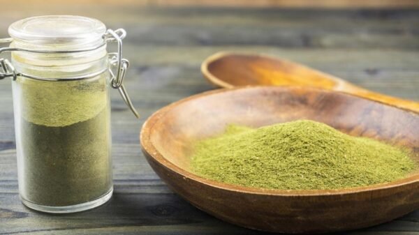 Natural pain reliever Kratom in a mixing bowl at our organic apothecary herbal shop in Borneo being measured to sell.